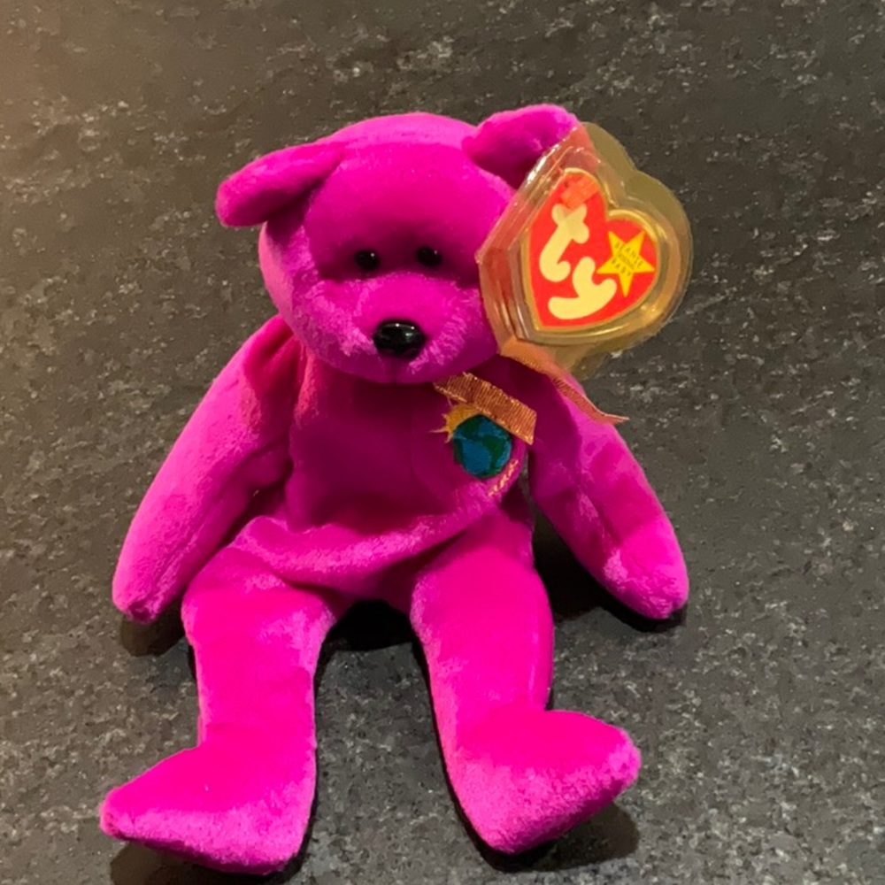 TY BABY MILLENIUM BEAR WITH PROTECTIVE TAG HOLDER.